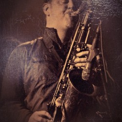 A man holding a saxophone in his hands.